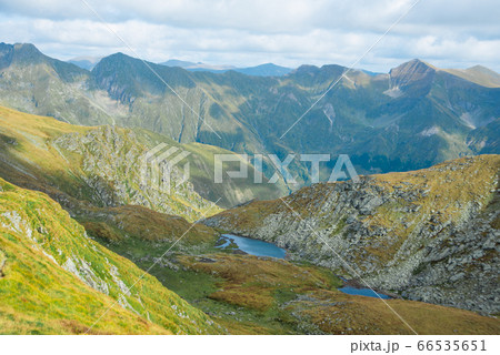 Breathtaking landscape in Carpathian mountains. With high green hills, rocks and small lakes Breathtaking landscape in Carpathian mountains. With high green hills, rocks and small lakes 66535651