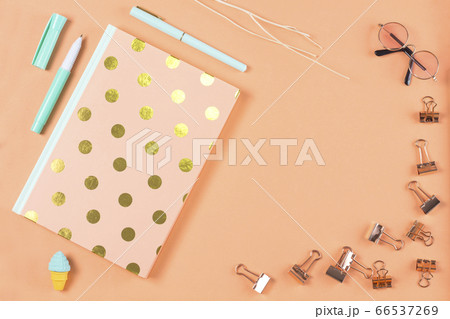 flat lay stationery on work desk in orange pastel background flat lay stationery on work desk in orange pastel background 66537269