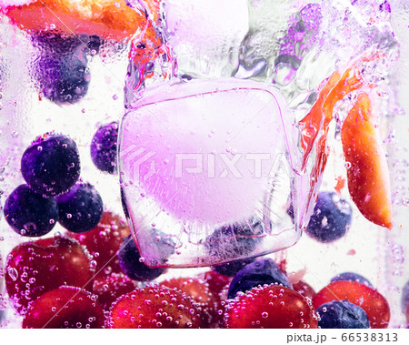 Close up view of the cold and fresh lemonade with bright berries in neon light 66538313
