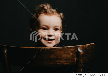 face of a happy smiling Caucasian child boy on a dark background face of a happy smiling Caucasian child boy on a dark background 66538714