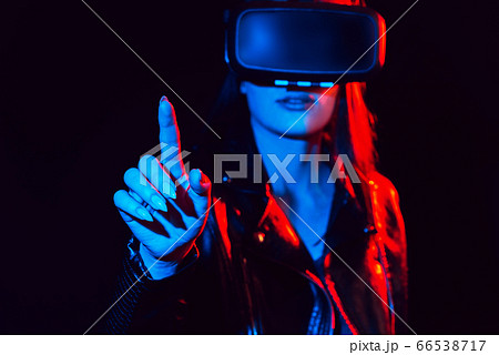 girl in 3D virtual reality glasses touches the projection screen with her finger 66538717