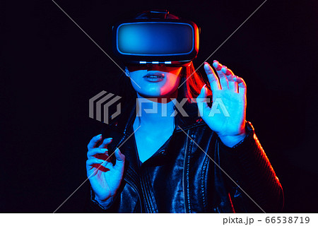 emotional girl in virtual reality glasses plunges into cyberspace 66538719