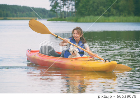 Woman and her dog on a kayak 66539079