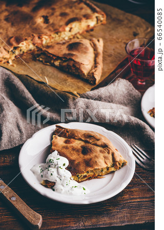 Slice of cabbage pie with sour cream sauce 66540085