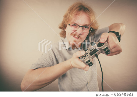 Gamer man holding gaming pad Gamer man holding gaming pad 66540933