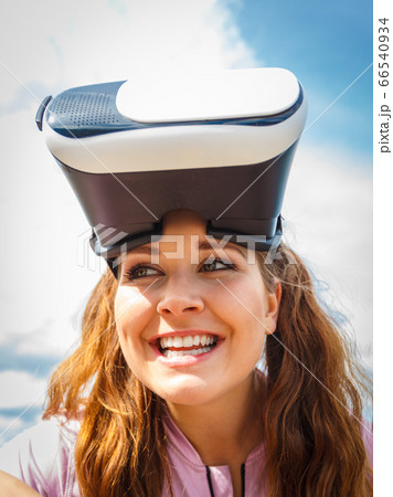 Woman wearing VR outside Woman wearing VR outside 66540934