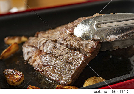 ステーキをトングで持つ 66541439