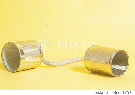 Tin can phone on a yellow background . Tin can phone on a yellow background . 66541752