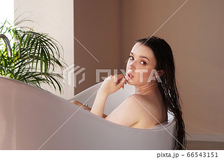 Young attractive woman relaxing in bath 66543151