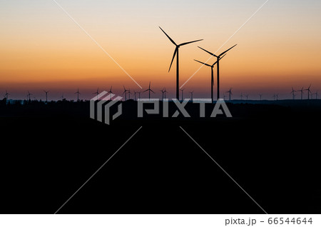 Black Silhouette of windturbines energy generator on amazing sunset at a wind farm in germany Black Silhouette of windturbines energy generator on amazing sunset at a wind farm in germany 66544644