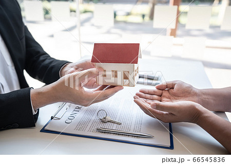Real estate agent are presenting home loan and 66545836