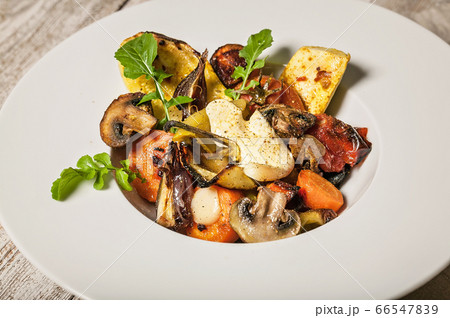 Close-up baked vegetables and mushrooms with 66547839