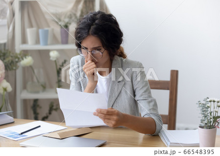 Pensive Caucasian woman feel frustrated reading letter 66548395