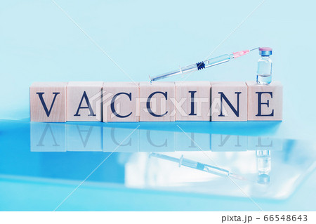 Syringe and vaccine text on blue 66548643