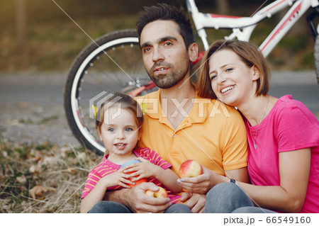 Family with a bicycle in a summer park 66549160