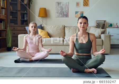 Practicing meditation with teenage daughter 66550247