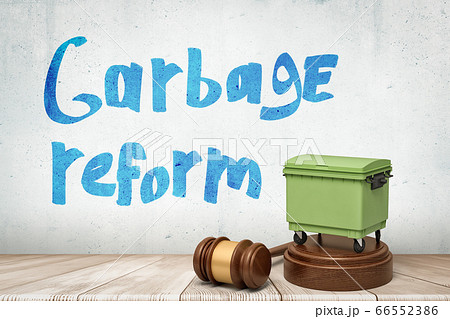 3d rendering of green trash bin on round wooden block with brown wooden gavel and 'Garbage reform' sign on white wooden floor background 66552386
