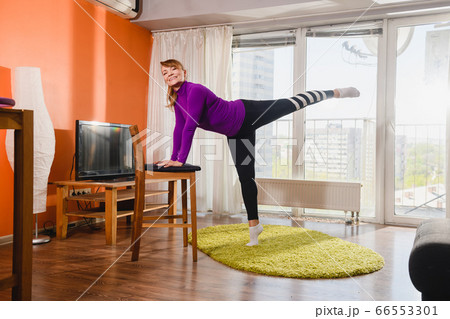 Positive aged woman training at living room Positive aged woman training at living room 66553301