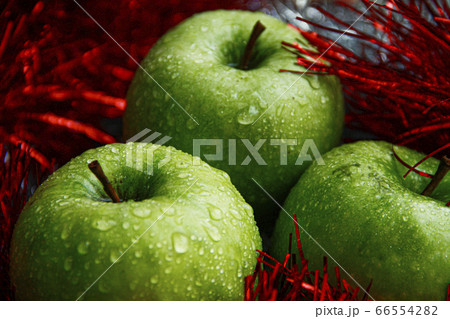 Triple fresh green apples with water drops on them 66554282