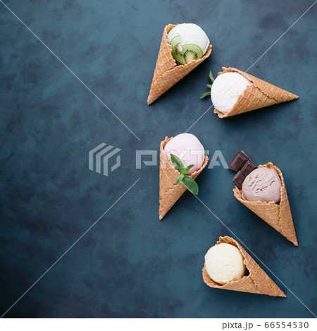 Ice cream cones of different colors and flavors 66554530