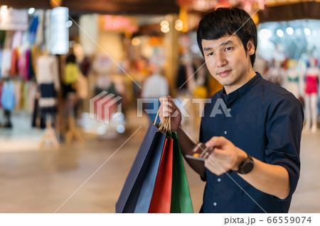young asian man wearing medical mask and holding young asian man wearing medical mask and holding 66559074