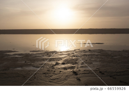 Traces of a man on a sandy beach by the lake before sunset. Traces of a man on a sandy beach by the lake before sunset. 66559926