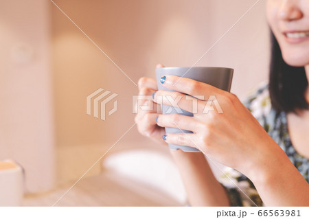 hands holding hot cup of coffee or tea in morning sunlight hands holding hot cup of coffee or tea in morning sunlight 66563981