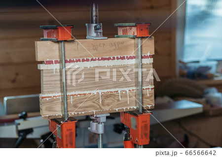 Bonding wood in the workshop. The use of glue for different types of wood. Making worktops for the kitchen. Work as a craftsman. Creating a cutting board design Bonding wood in the workshop. The use of glue for different types of wood. Making worktops for the kitchen. Work as a craftsman. Creating a cutting board design 66566642