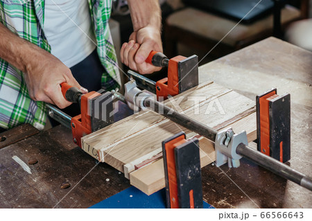Bonding wood in the workshop. The use of glue for different types of wood. Making worktops for the kitchen. Work as a craftsman. Creating a cutting board design 66566643