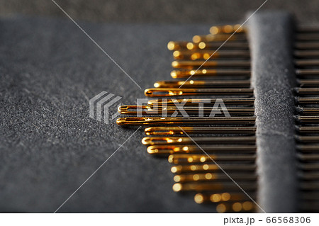 A set of sewing needles on a black background. A set of sewing needles on a black background. 66568306