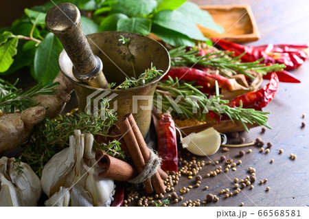 Different herbs and spices on a wooden table . 66568581