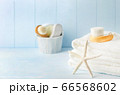 Close up of starfish and white towels with Facial cleansing brush 66568602