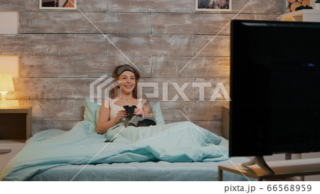 Zoom in shot of beautiful woman in pajamas at night 66568959