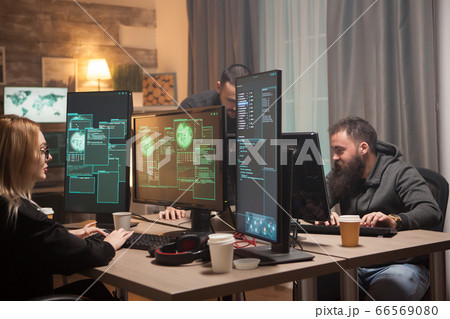 Organised hackers in a room with computers 66569080