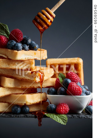 Belgian waffles with  blueberries, raspberries  66569540
