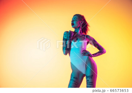Portrait of young caucasian woman on gradient yellow background with copyspace, unusual and freaky appearance 66573653