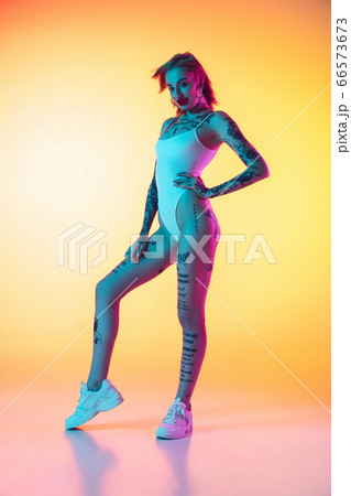 Portrait of young caucasian woman on gradient yellow background with copyspace, unusual and freaky appearance 66573673