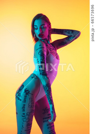 Portrait of young caucasian woman on gradient yellow background with copyspace, unusual and freaky appearance Portrait of young caucasian woman on gradient yellow background with copyspace, unusual and freaky appearance 66573696