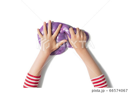 Child hands and purple shiny slime.  66574067