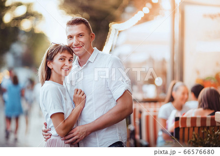 Happy attractive couple, charming woman hugging her handsome stylish boyfriend. Summer Europe vacation, date, romance Happy attractive couple, charming woman hugging her handsome stylish boyfriend. Summer Europe vacation, date, romance 66576680