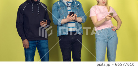 Group of friends using mobile smartphones. Teenagers addiction to new technology trends. Close up. 66577610