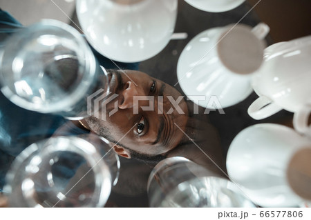 African-american man looking for job in unusual places at his home 66577806