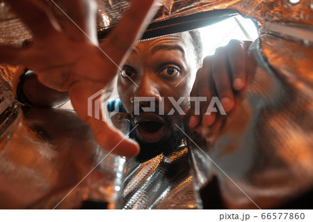 African-american man looking for job in unusual places at his home 66577860