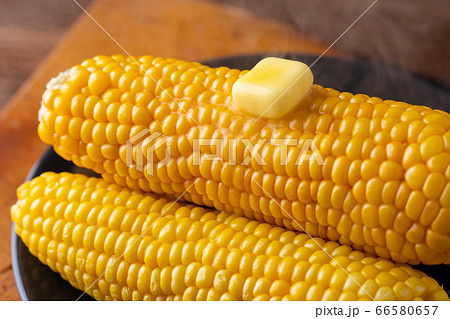 Melted butter on sweet corn. 66580657