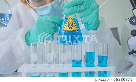 Asian Scientist working on blue test tube to Asian Scientist working on blue test tube to 66580875