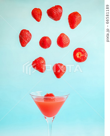Strawberry levitation over a glass with strawberry Strawberry levitation over a glass with strawberry 66581189