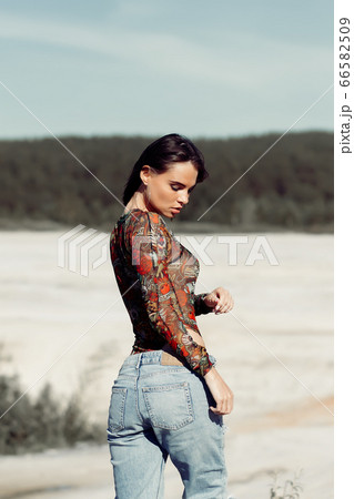 Sensual young lady on beach 66582509