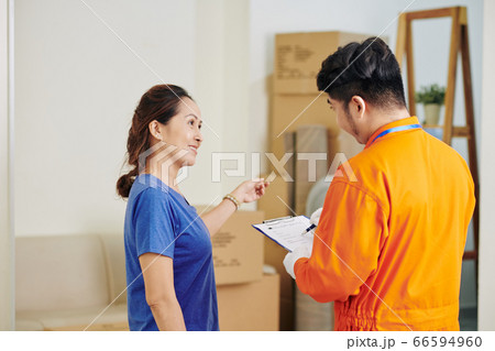 Mature Woman Talking With Delivery Man 66594960