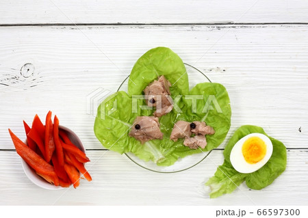 Cod liver on the lettuce leaves, white table 66597300