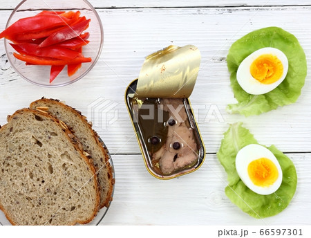 Cod liver in a tin  on white table, flat lay 66597301